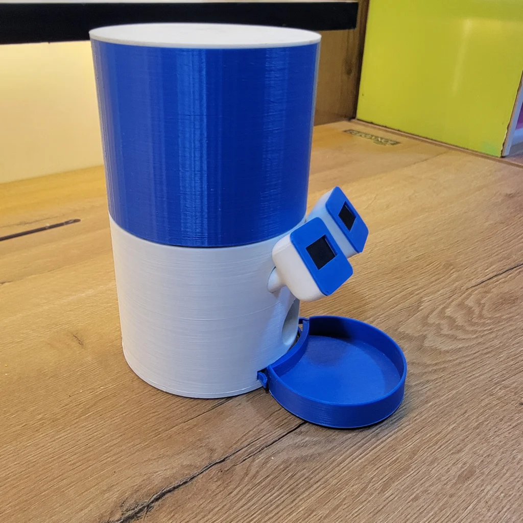 Smart ESP32 WiFi automatic cat feeder with a cat eating dry food from its 3D-printed feeding bowl